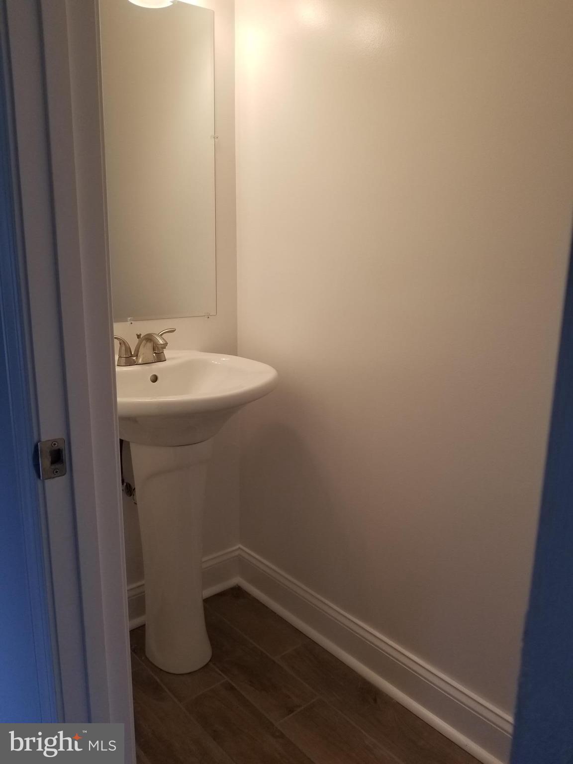 6828 Campfield Road Baltimore, MD 21207 - Photo 2 of 26 a bathroom with a sink and mirror