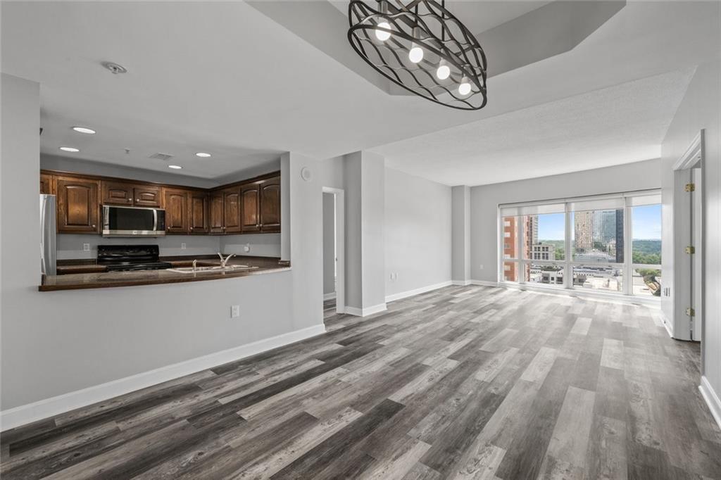 3475 Oak Valley Road Northeast, Unit 910 Atlanta, GA 30326 - Photo 11 of 27 a open kitchen with stainless steel appliances granite countertop a refrigerator and microwave