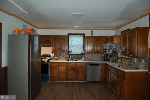 a kitchen with a sink stove and refrigerator