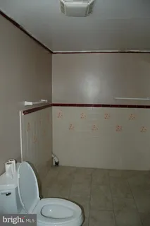 a bathroom with a toilet a sink and a shower