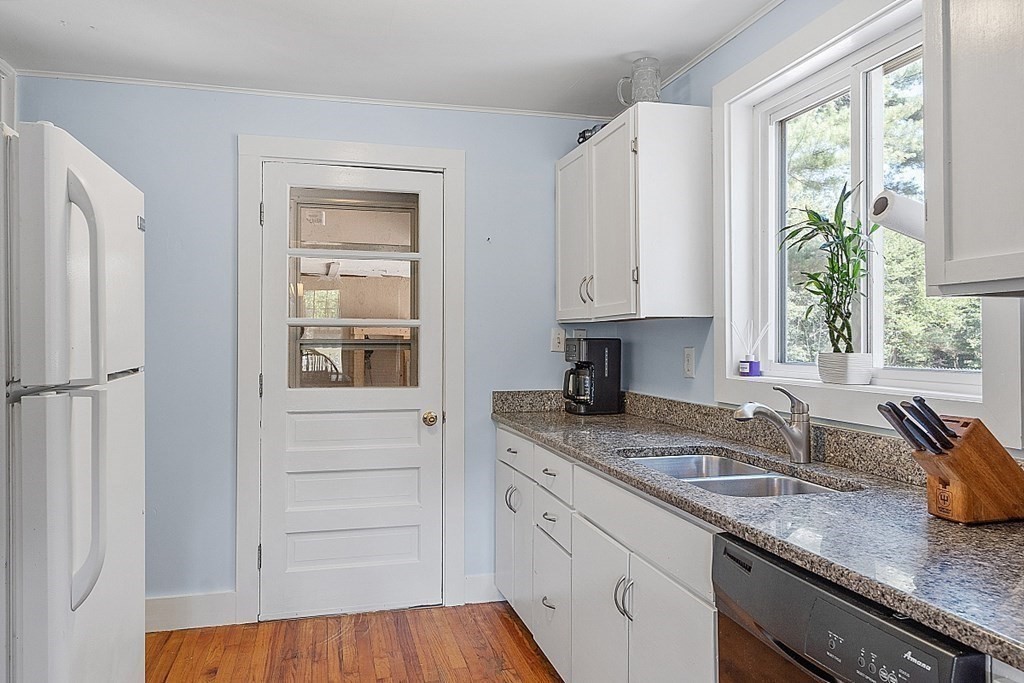 175 Forge Village Road Groton, MA 01450 - Photo 14 of 26 a kitchen with granite countertop stainless steel appliances a sink window and cabinets
