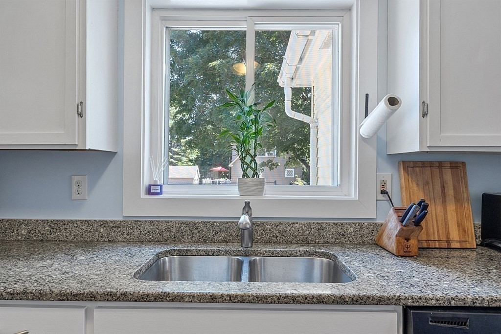 175 Forge Village Road Groton, MA 01450 - Photo 15 of 26 a kitchen with granite countertop a sink window and cabinets