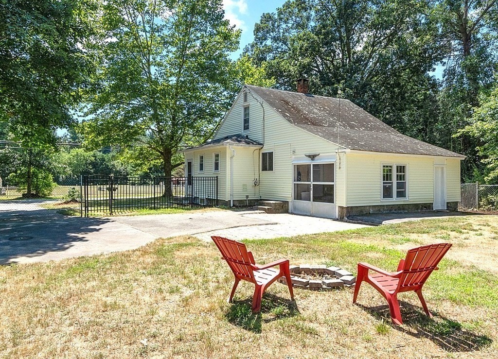 175 Forge Village Road Groton, MA 01450 - Photo 25 of 26 a backyard of a house with table and chairs