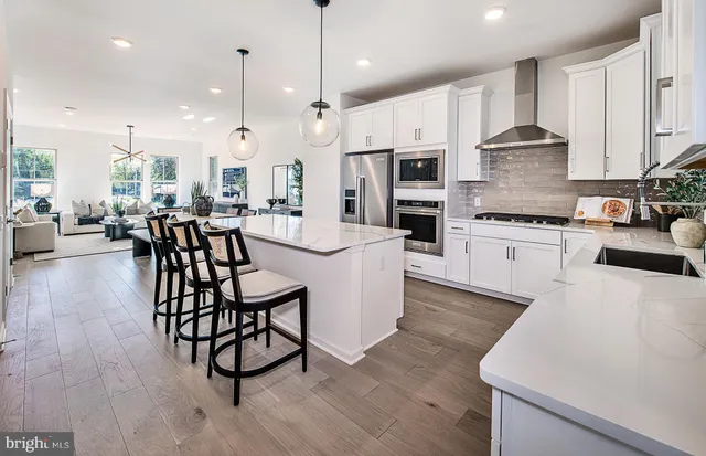 a large kitchen with a table and chairs