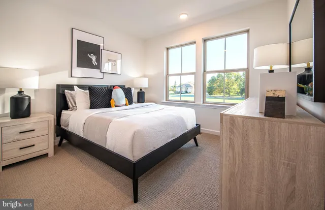 a bedroom with a bed and a large window