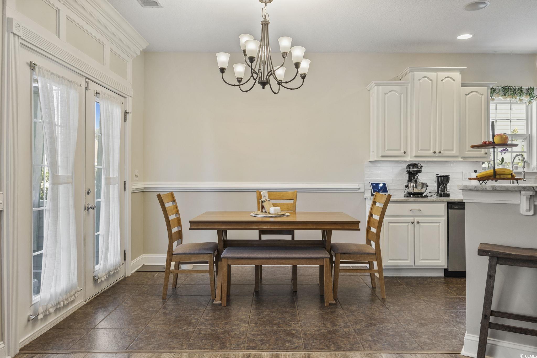 418 Cabo Loop Myrtle Beach, SC 29588 - Photo 12 of 40 Dining space with a chandelier and french doors
