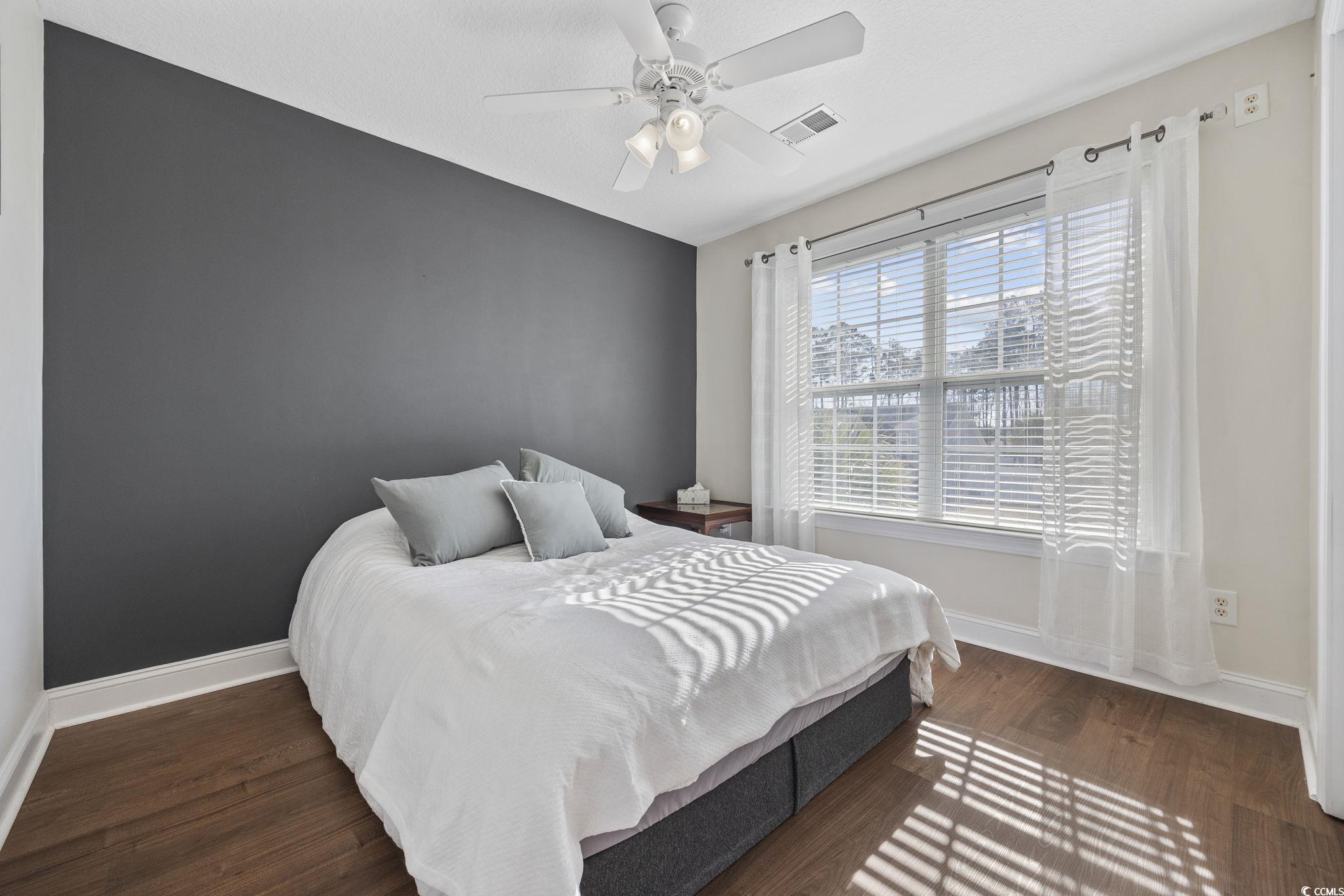 418 Cabo Loop Myrtle Beach, SC 29588 - Photo 22 of 40 Bedroom featuring dark wood finished floors and a ceiling fan
