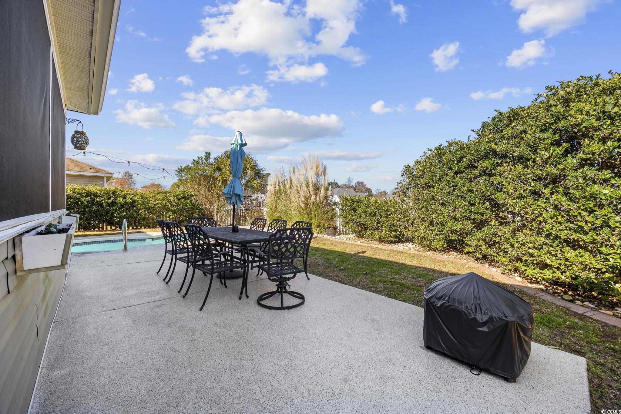 418 Cabo Loop Myrtle Beach, SC 29588 - Photo 32 of 40 View of patio / terrace with an outdoor pool, grilling area, and outdoor dining area
