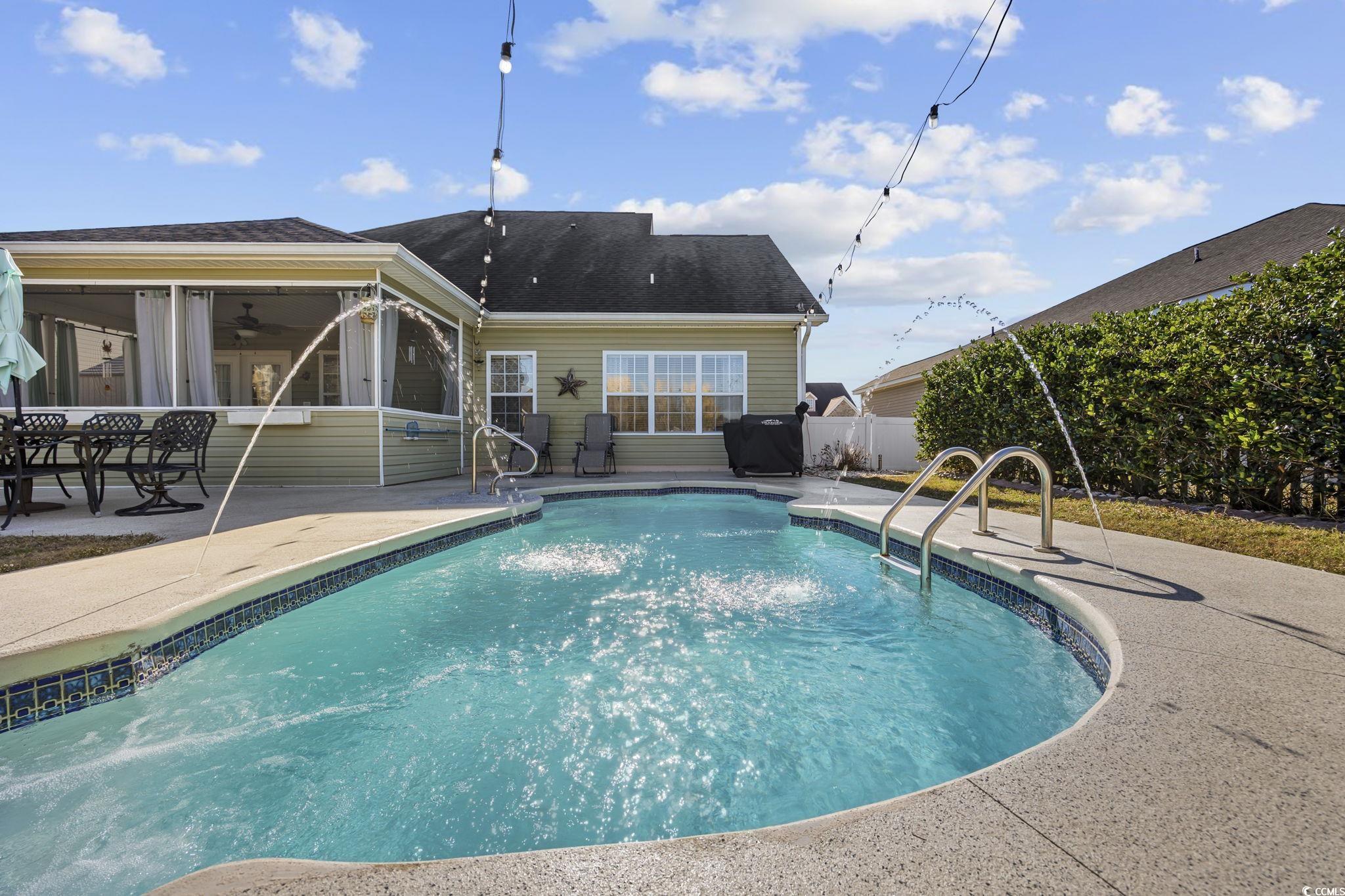 418 Cabo Loop Myrtle Beach, SC 29588 - Photo 34 of 40 View of pool with a patio area, a sunroom, and a fenced backyard