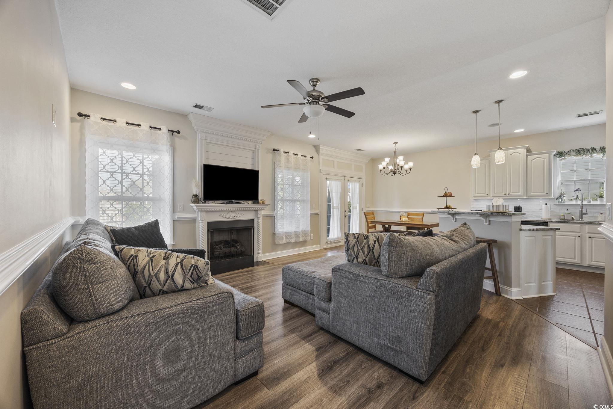 418 Cabo Loop Myrtle Beach, SC 29588 - Photo 5 of 40 Living area featuring ceiling fan, a large fireplace, dark wood-type flooring, healthy amount of natural light, and recessed lighting