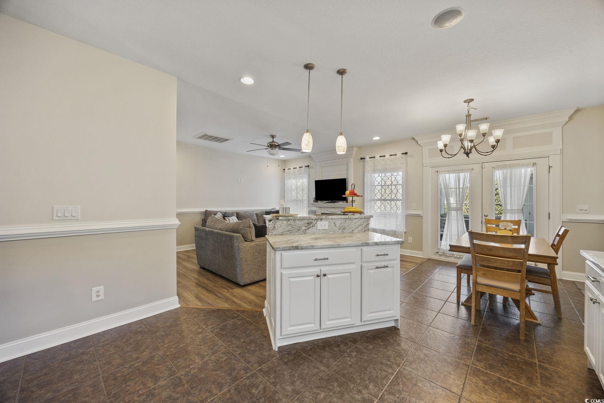 418 Cabo Loop Myrtle Beach, SC 29588 - Photo 39 of 40 Kitchen with light stone countertops, pendant lighting, open floor plan, recessed lighting, and a ceiling fan