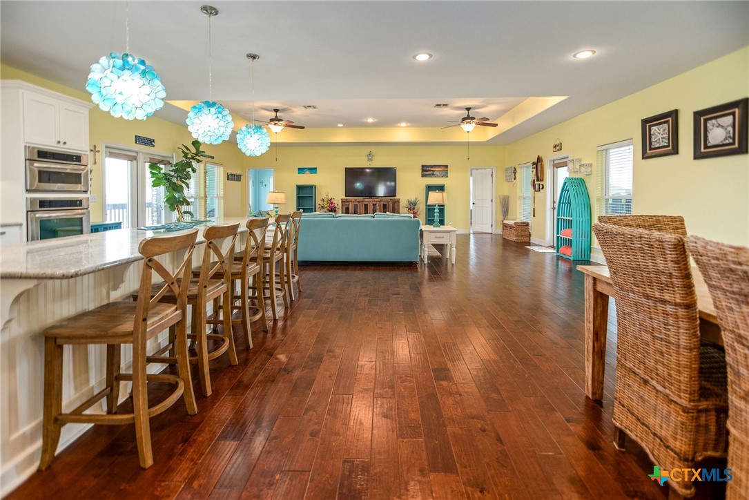 23 Macey Street Port O'Connor, TX 77982 - Photo 31 of 47 a view of a dining room with furniture and wooden floor