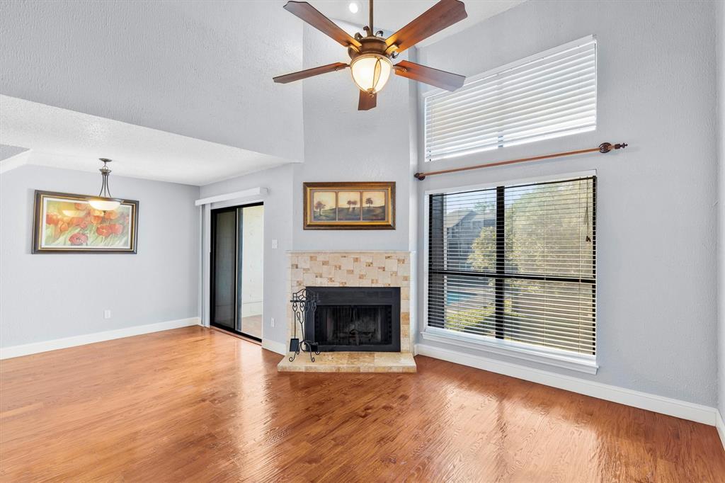 5840 Spring Valley Road, Unit 912 Dallas, TX 75254 - Photo 1 of 33 an empty room with windows and fireplace