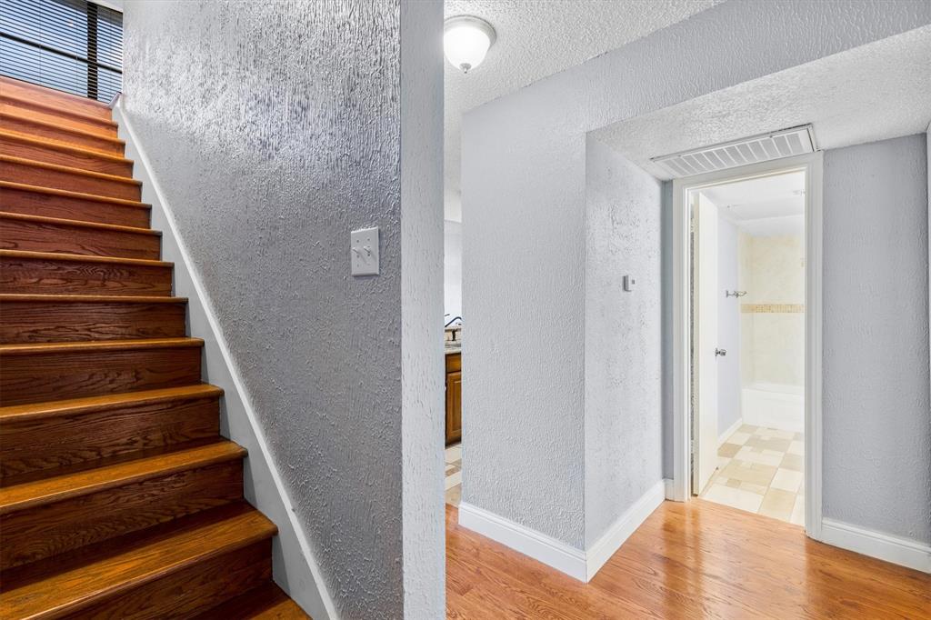 5840 Spring Valley Road, Unit 912 Dallas, TX 75254 - Photo 18 of 33 a view of entryway with wooden floor and stairs