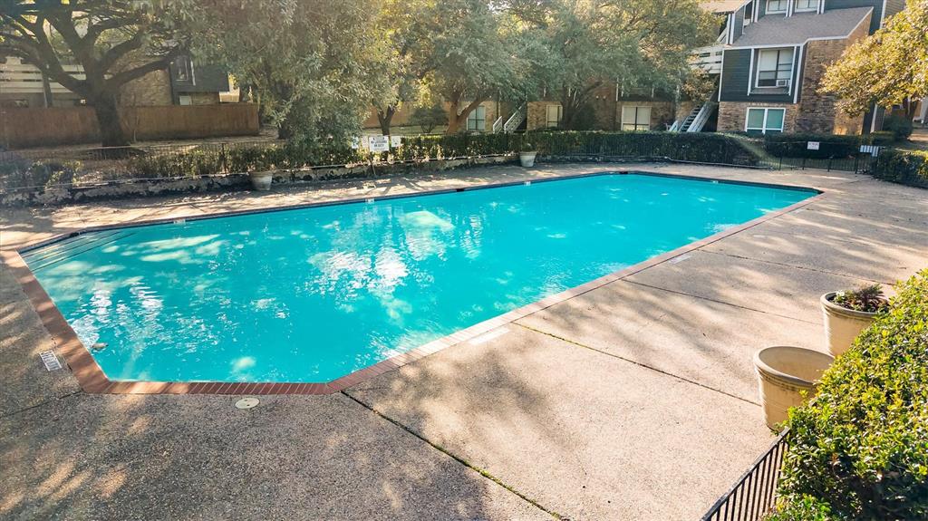 5840 Spring Valley Road, Unit 912 Dallas, TX 75254 - Photo 23 of 33 a view of a swimming pool with a yard