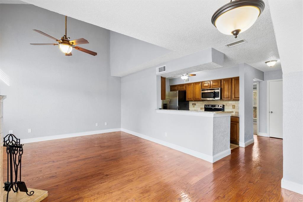 5840 Spring Valley Road, Unit 912 Dallas, TX 75254 - Photo 4 of 33 a view interior of a house livingroom and chandelier