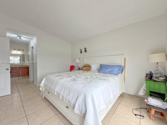 16955 Southwest 142nd Place Miami, FL 33177 - Photo 23 of 29 a bedroom with a bed and a view of kitchen