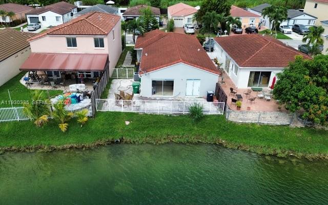 16955 Southwest 142nd Place Miami, FL 33177 - Photo 4 of 29 a aerial view of a house with a yard table and chairs