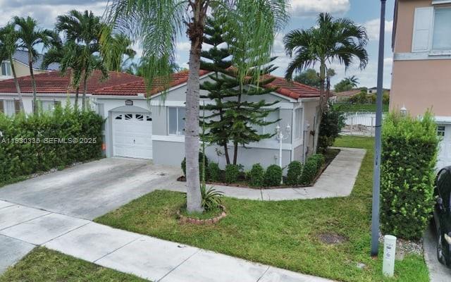 16955 Southwest 142nd Place Miami, FL 33177 - Photo 6 of 29 a front view of a house with garden