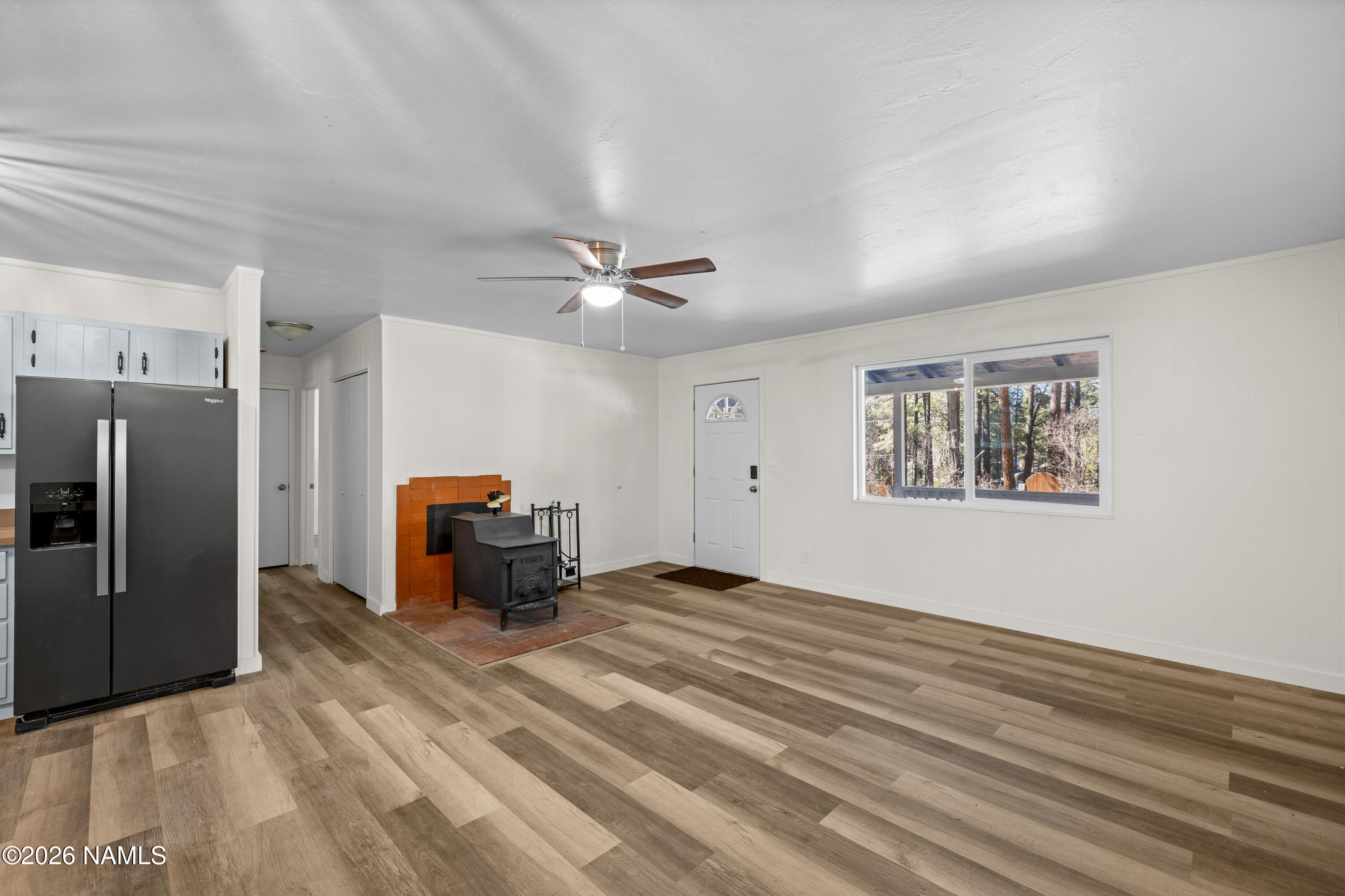 874 Oneida Flagstaff, AZ 86005 - Photo 11 of 30 a living room with a bed furniture and a ceiling fan