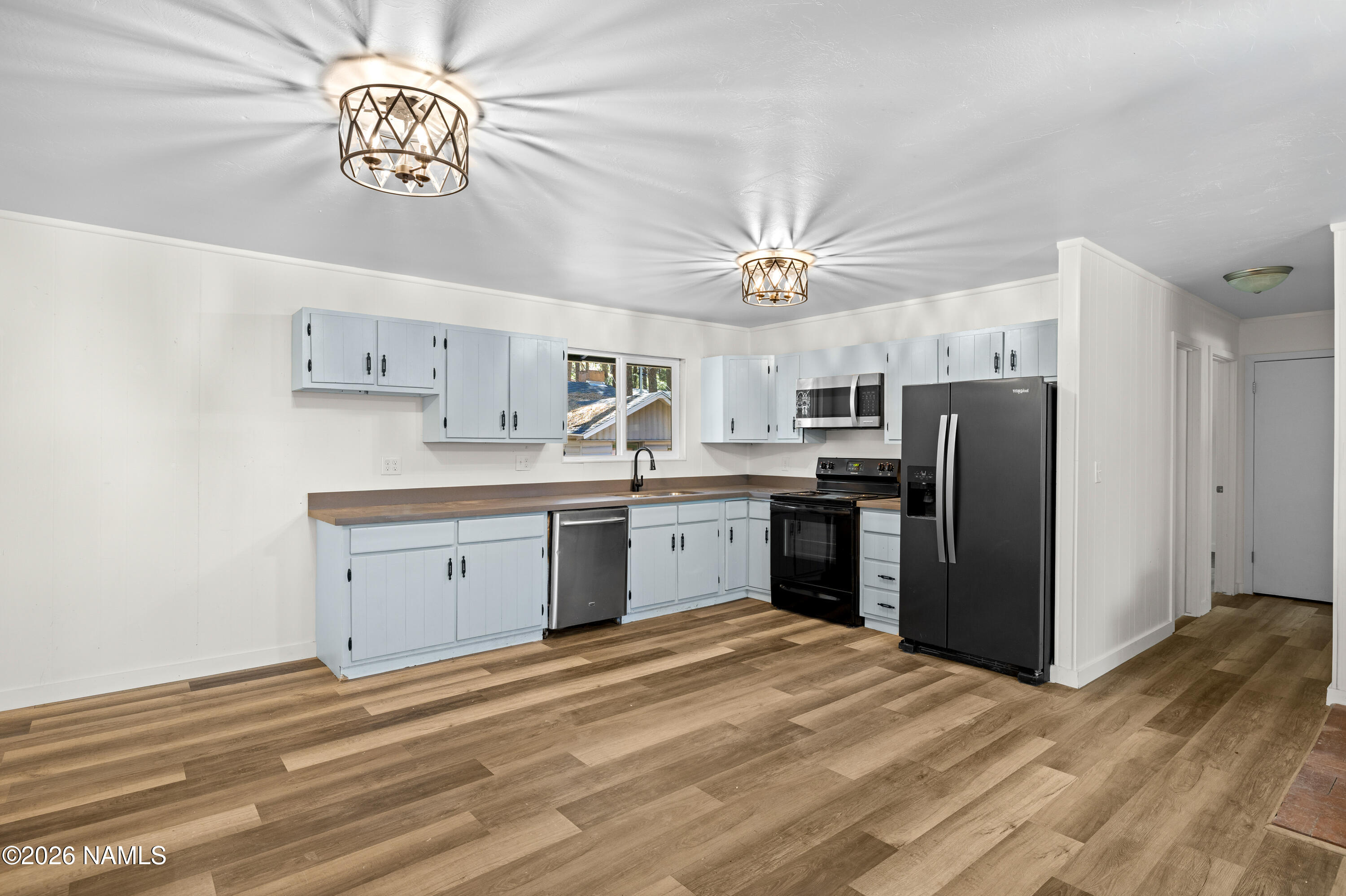 874 Oneida Flagstaff, AZ 86005 - Photo 17 of 30 a kitchen with stainless steel appliances a refrigerator a sink dishwasher a stove and white cabinets