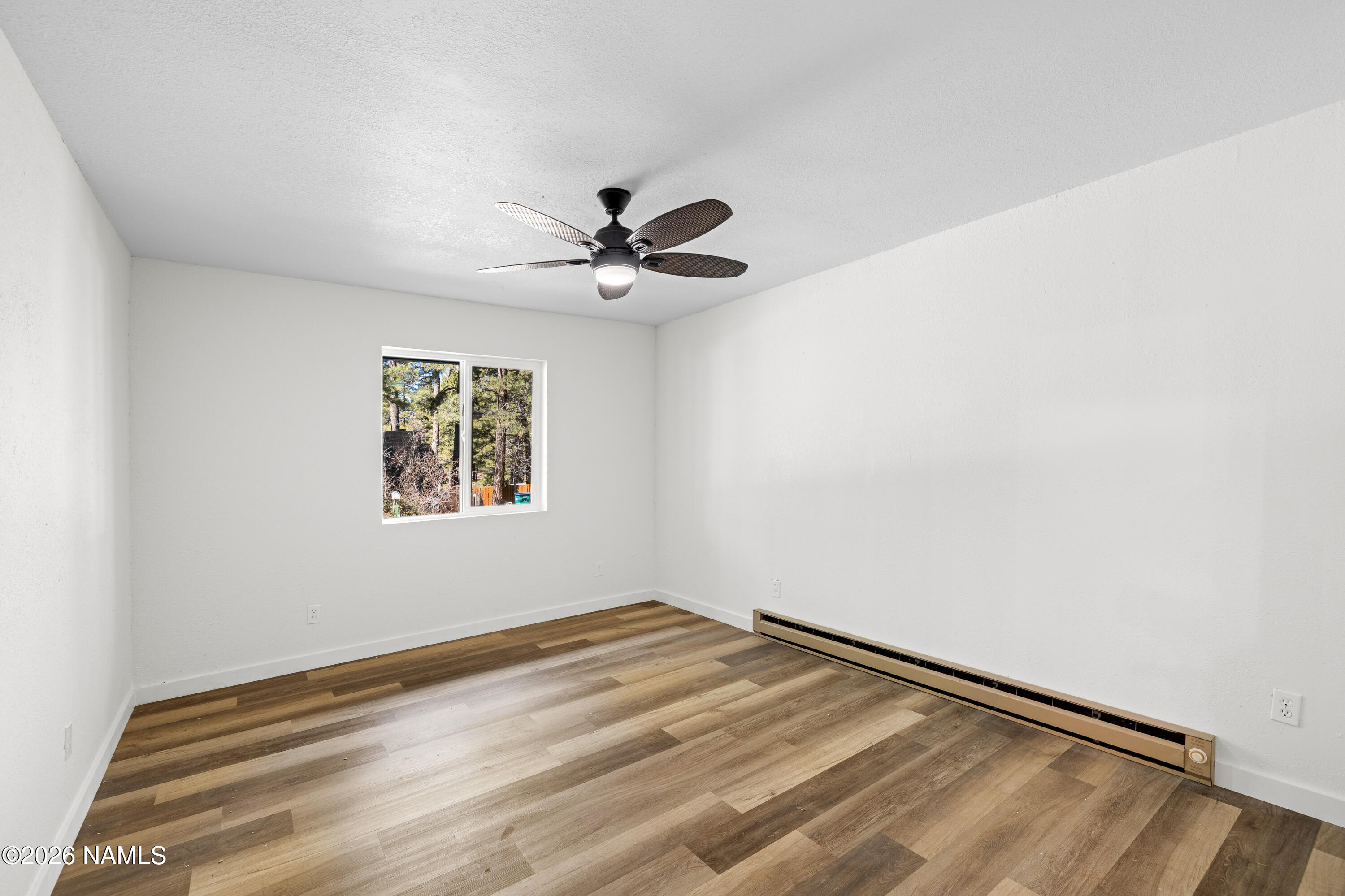 874 Oneida Flagstaff, AZ 86005 - Photo 19 of 30 an empty room with a window and ceiling fan