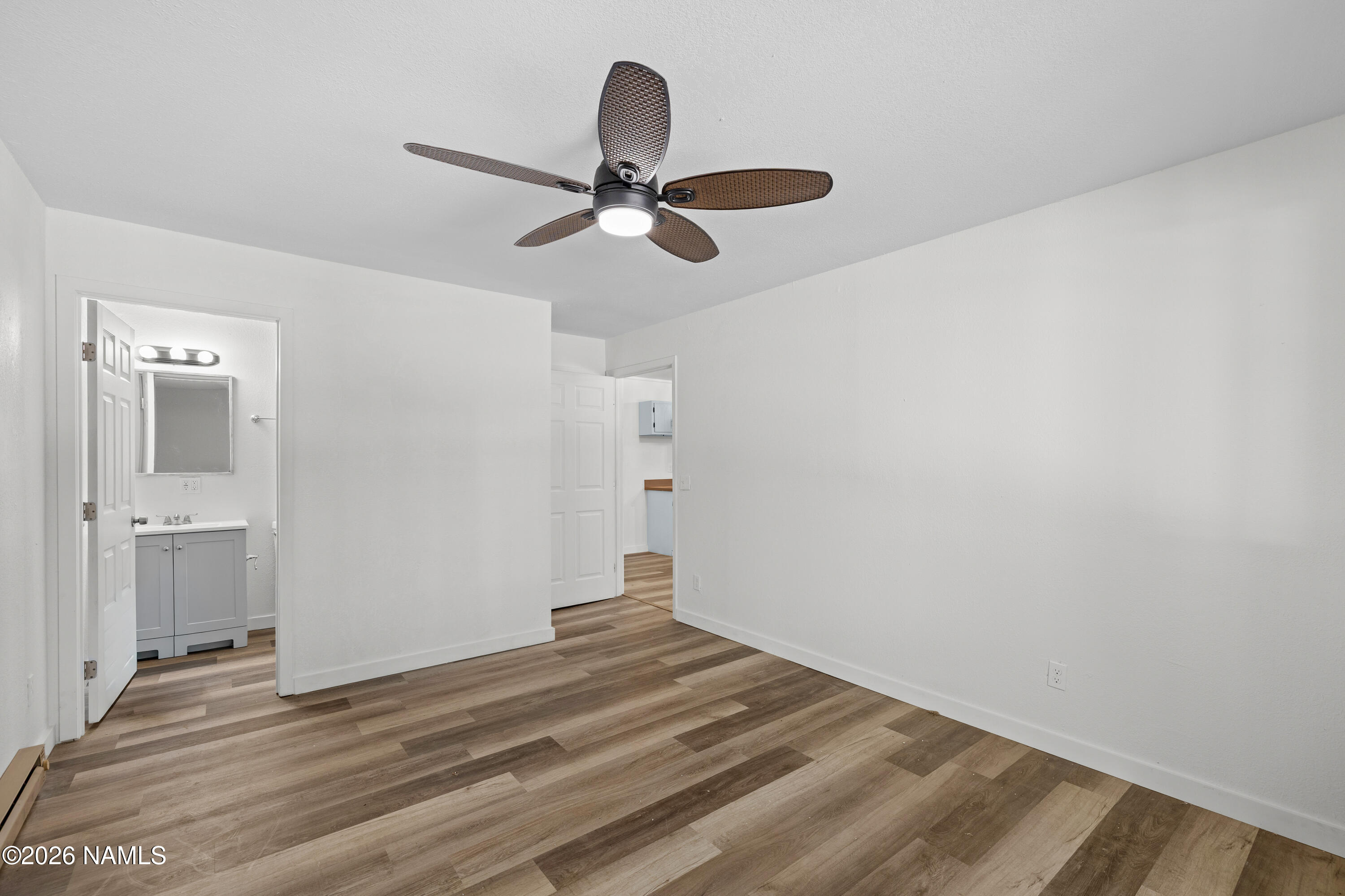 874 Oneida Flagstaff, AZ 86005 - Photo 22 of 30 a view of a livingroom with wooden floor and ceiling fan