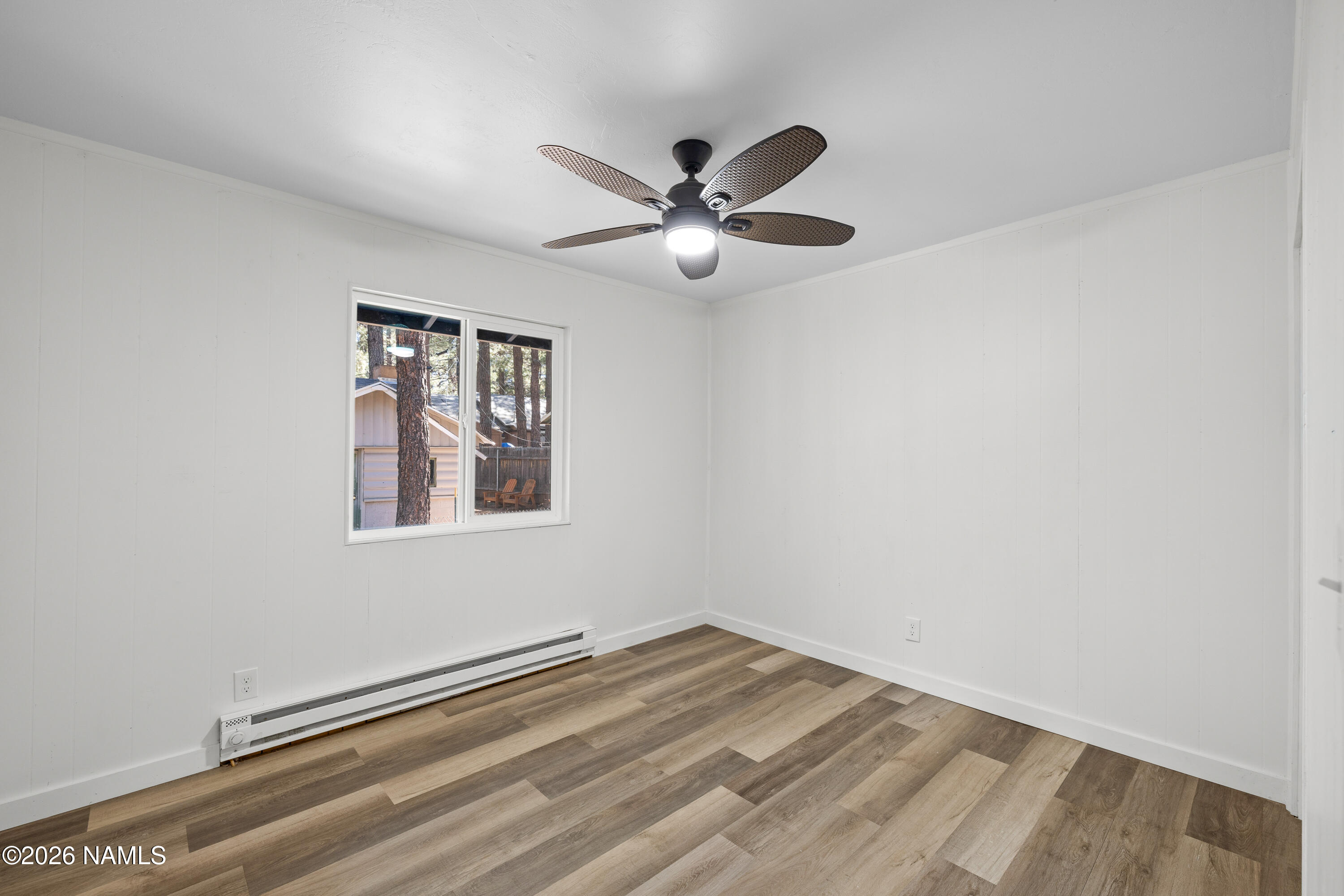 874 Oneida Flagstaff, AZ 86005 - Photo 27 of 30 a view of a big room with wooden floor and windows in a room