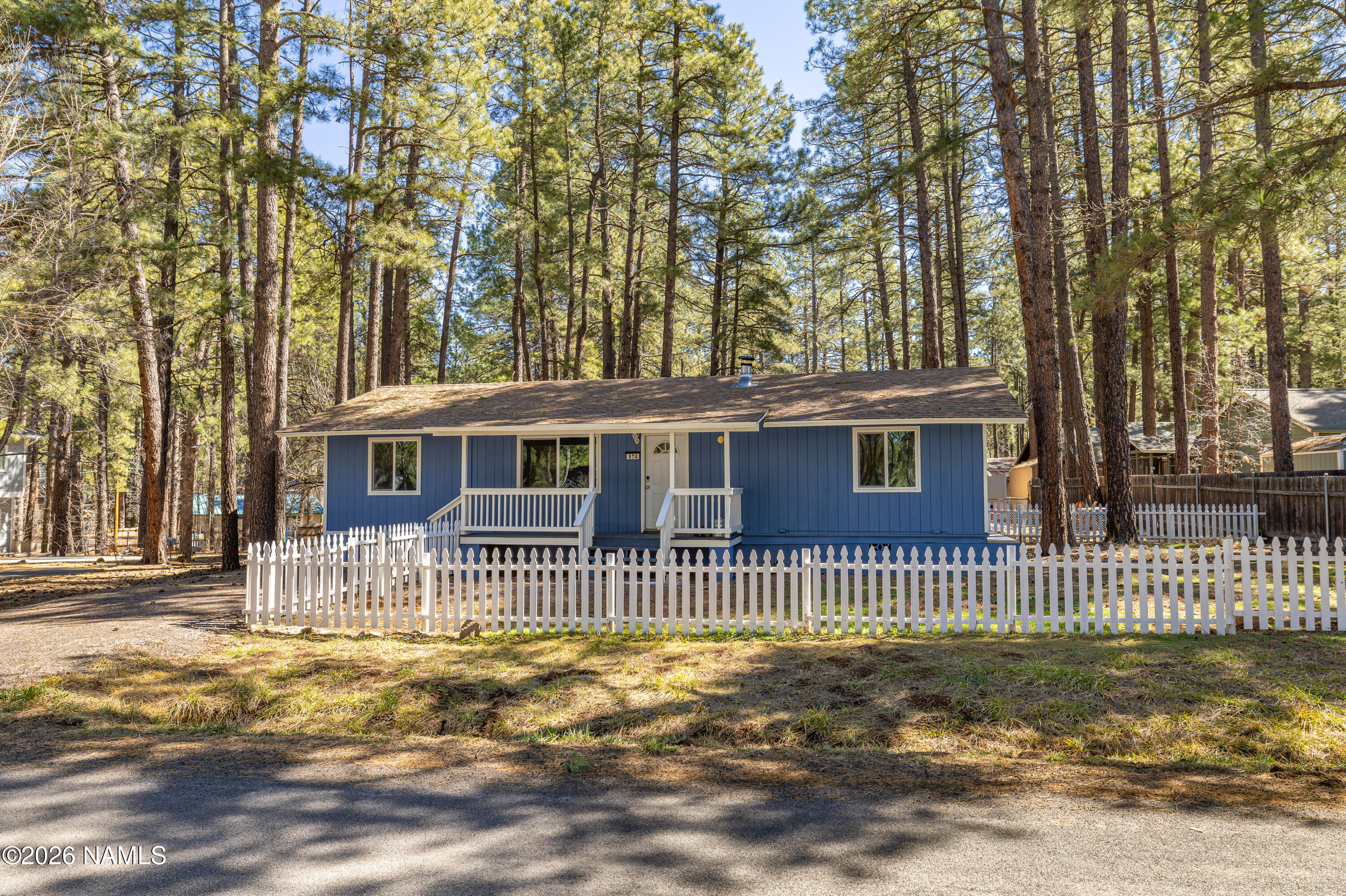 874 Oneida Flagstaff, AZ 86005 - Photo 3 of 30 a front view of a house with a garden