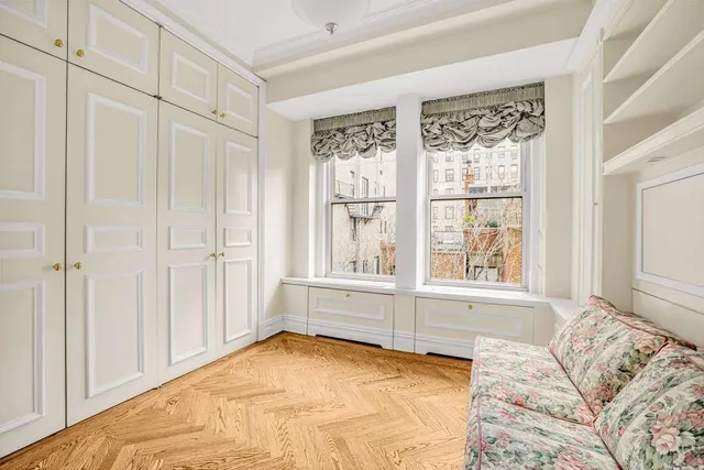 a bedroom with a bed and a potted plant