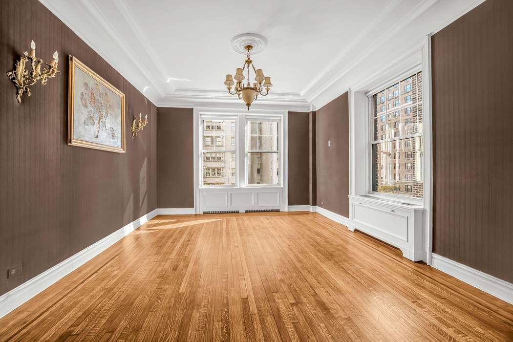 830 Park Avenue, Unit 5/6C Manhattan, NY 10021 - Photo 4 of 19 a view of an empty room with wooden floor and a window