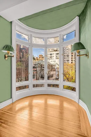 a view of a dining area with furniture window and wooden floor