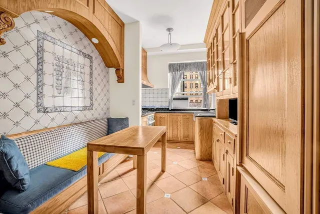 a kitchen with stainless steel appliances kitchen island granite countertop furniture and a refrigerator