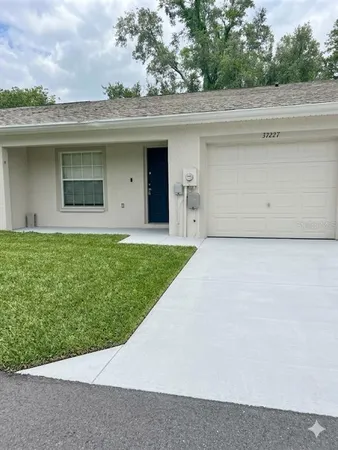 a front view of a house with a garden and yard