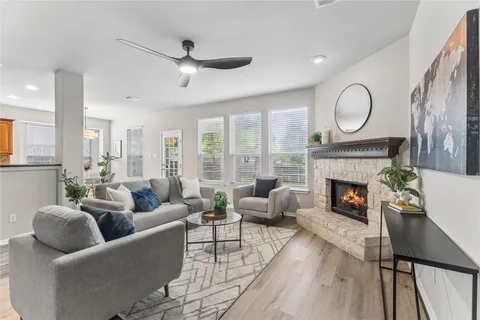 a living room with furniture fireplace and a large window