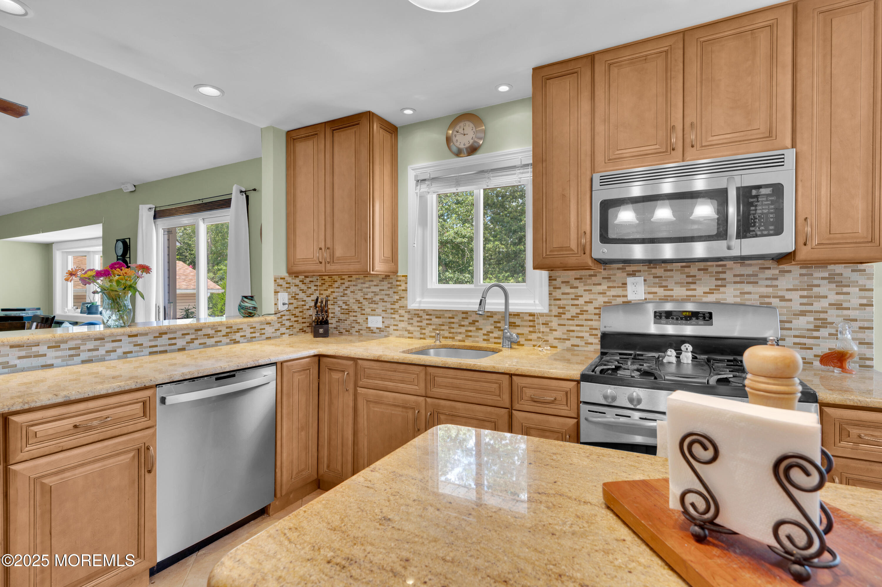 348 Hilltop Road Toms River, NJ 08753 - Photo 23 of 48 a kitchen with a sink a stove and cabinets