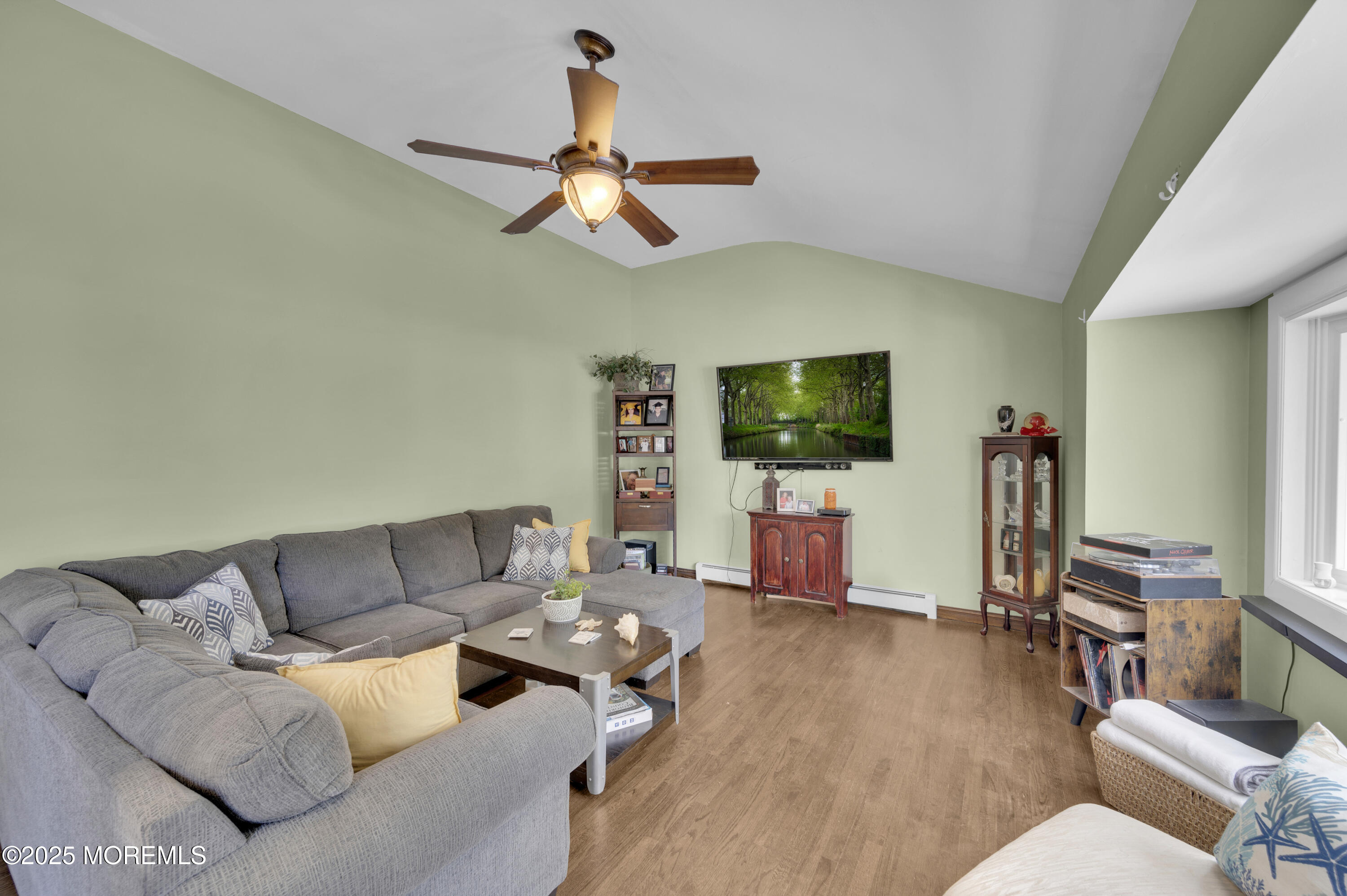 348 Hilltop Road Toms River, NJ 08753 - Photo 27 of 48 a living room with furniture a flat screen tv and wooden floor