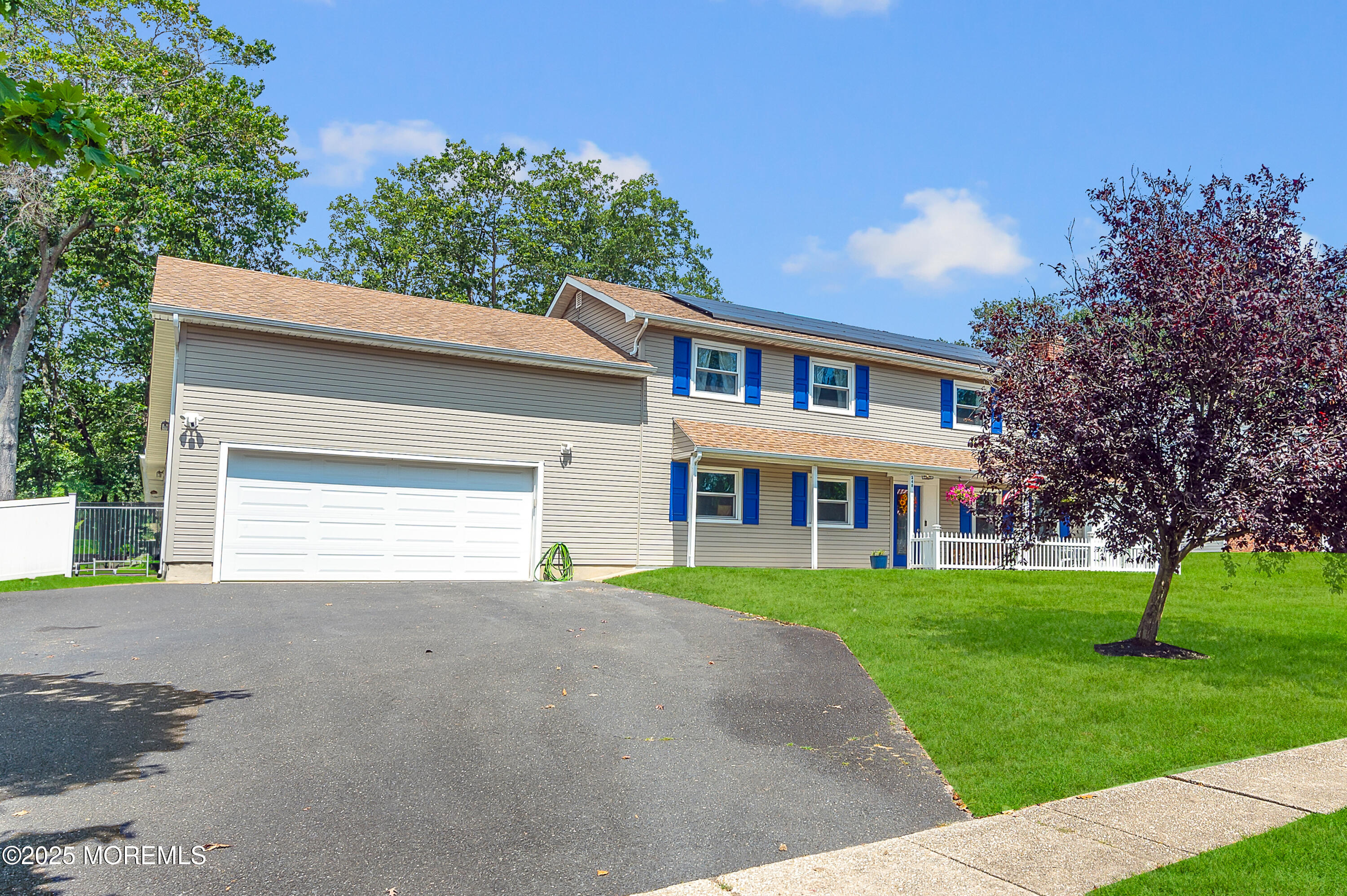 348 Hilltop Road Toms River, NJ 08753 - Photo 3 of 48 a front view of a house with a yard and garage