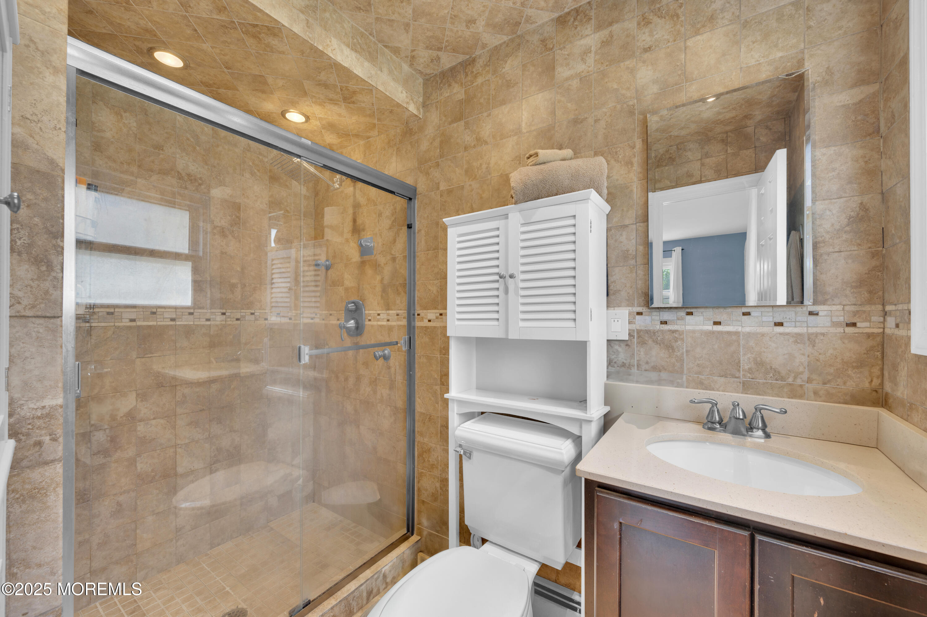 348 Hilltop Road Toms River, NJ 08753 - Photo 31 of 48 a bathroom with a sink toilet vanity and shower