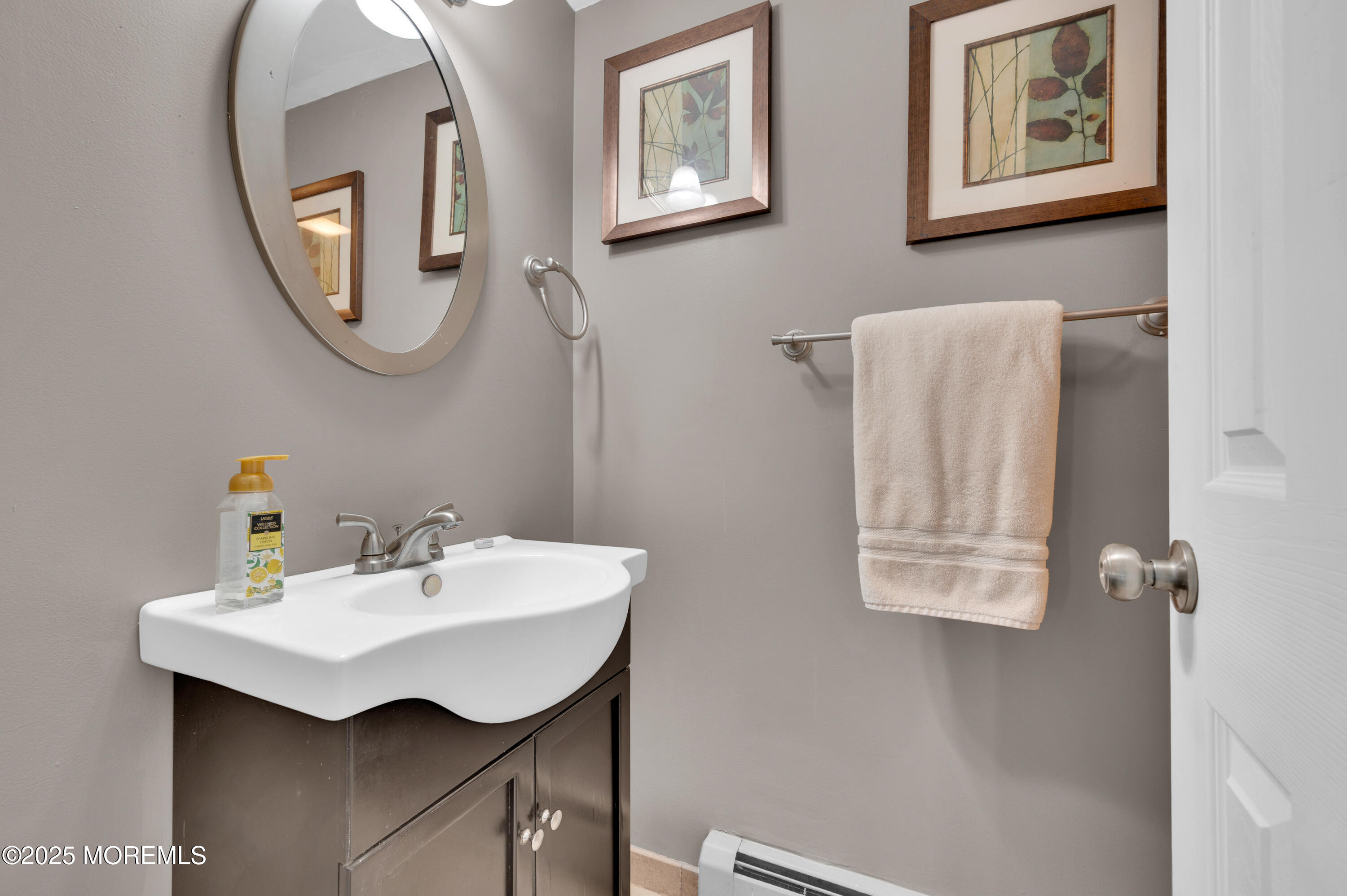 348 Hilltop Road Toms River, NJ 08753 - Photo 10 of 48 a bathroom with a sink and a mirror