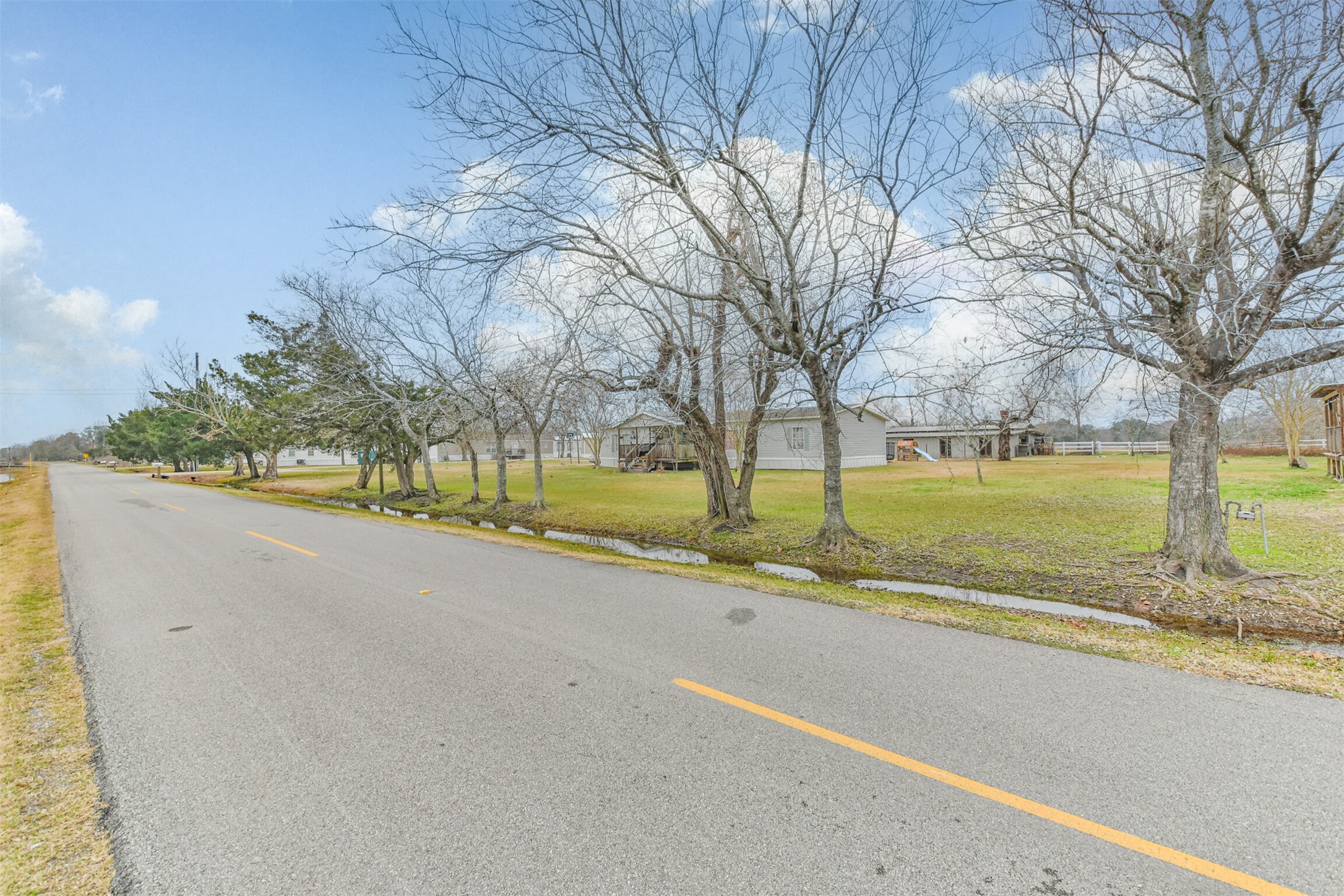 1300 North Battlebell Road Highlands, TX 77562 - Photo 11 of 16 a view of a street with a yard and large trees