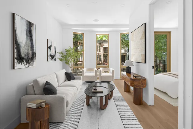 a living room with furniture fireplace and large windows