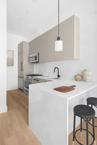 a kitchen with a sink cabinets and stainless steel appliances