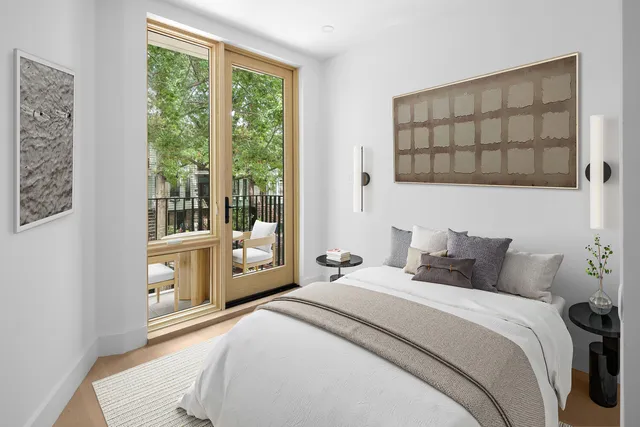 a bedroom with a large bed and a window