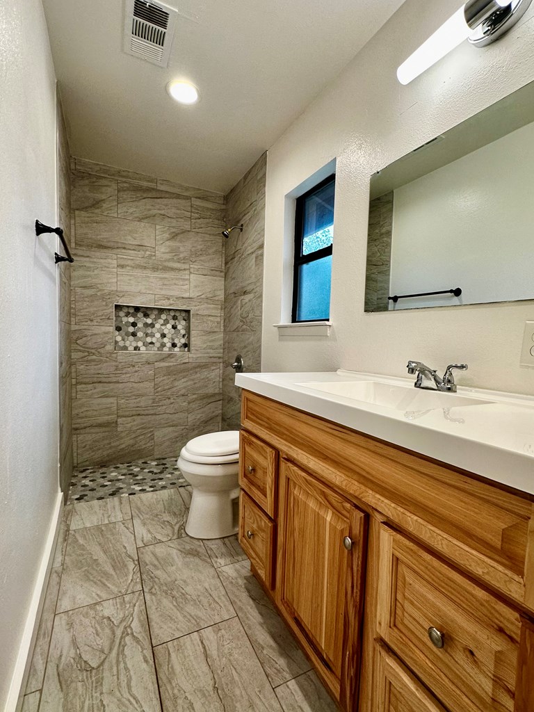 711 Center Street Kerrville, TX 78028 - Photo 9 of 9 a spacious bathroom with a sink a toilet and shower