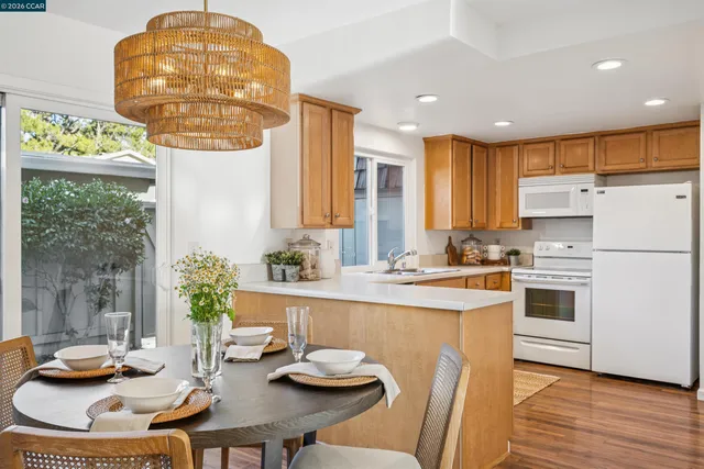 a kitchen with a sink refrigerator and cabinets