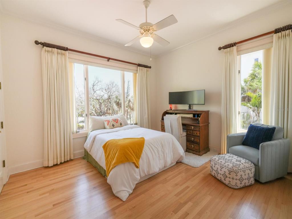 6060 Manasota Key Road Englewood, FL 34223 - Photo 15 of 54 a bedroom with a bed and wooden floor