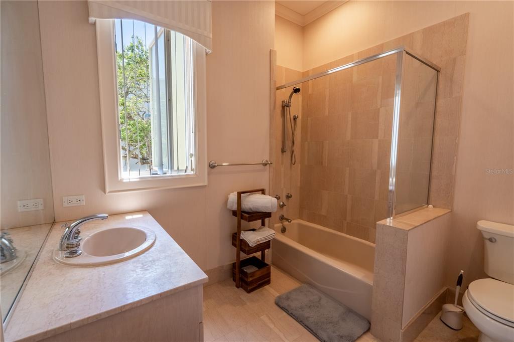 6060 Manasota Key Road Englewood, FL 34223 - Photo 16 of 54 a bathroom with a sink a toilet and a shower