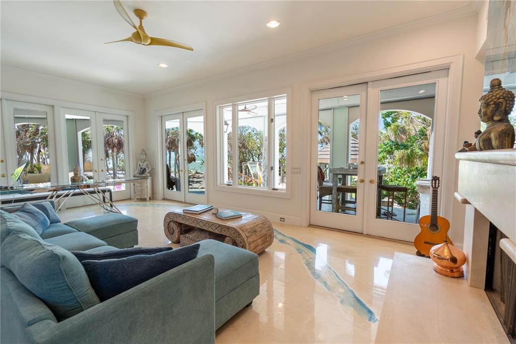 6060 Manasota Key Road Englewood, FL 34223 - Photo 21 of 54 a living room with furniture and a fireplace