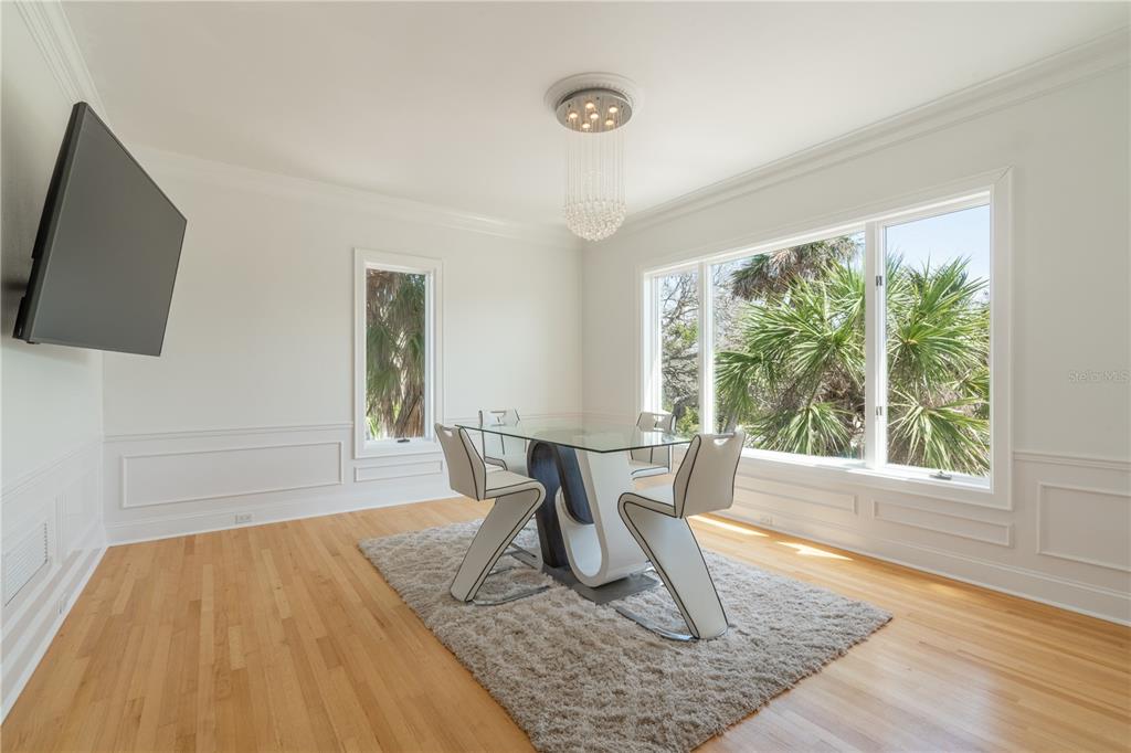 6060 Manasota Key Road Englewood, FL 34223 - Photo 24 of 54 a view of a work space with wooden floor and a floor to ceiling window